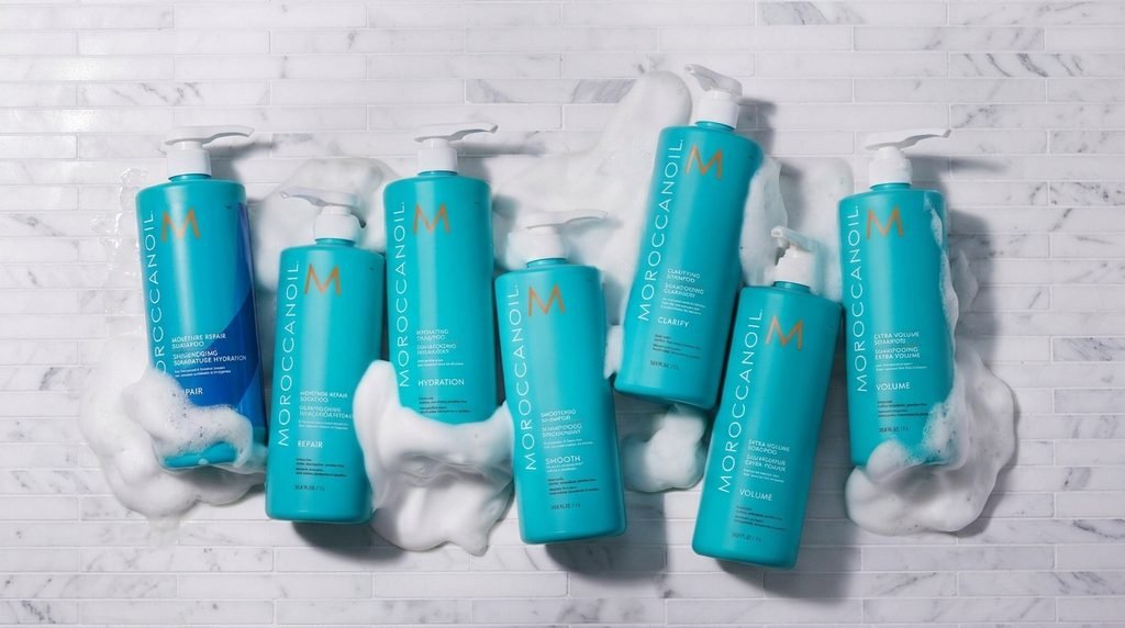 Argan oil and Moroccanoil haircare products arranged in a luxury still life