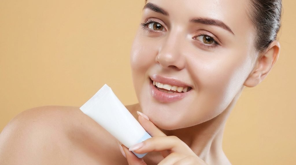 Woman holding a facial moisturizer while considering her daily skincare routine.