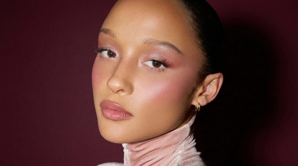 Close-up portrait showing a soft-focus blurred skin makeup look with diffused blush